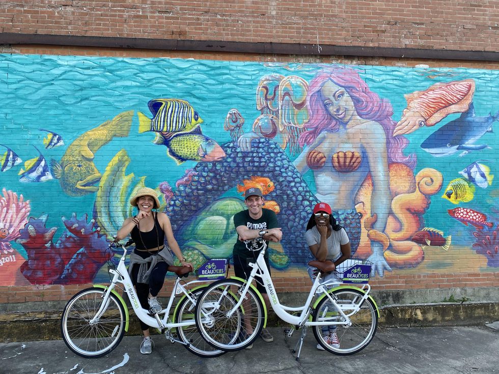 Bicyclists in front of mural in Beaumont