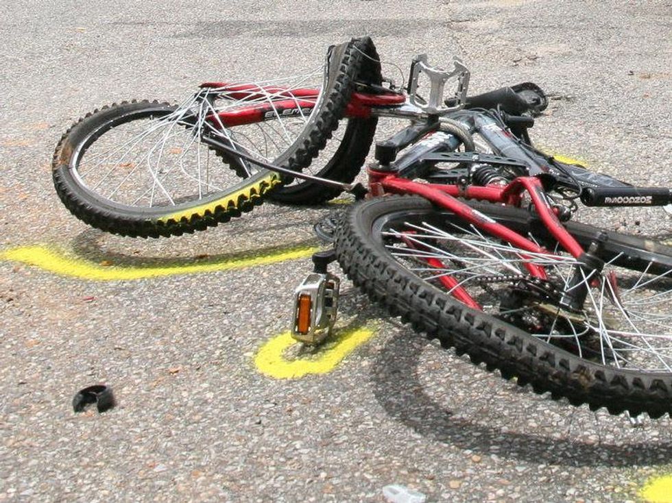 bike run over by truck with yellow spray paint marking it