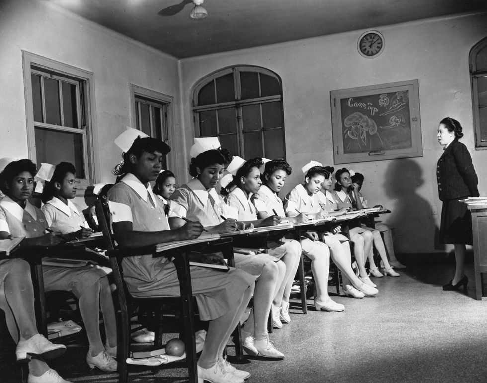 Black and white photo by Stephen Deutsch of a classroom full of Black women in nurses's uniforms