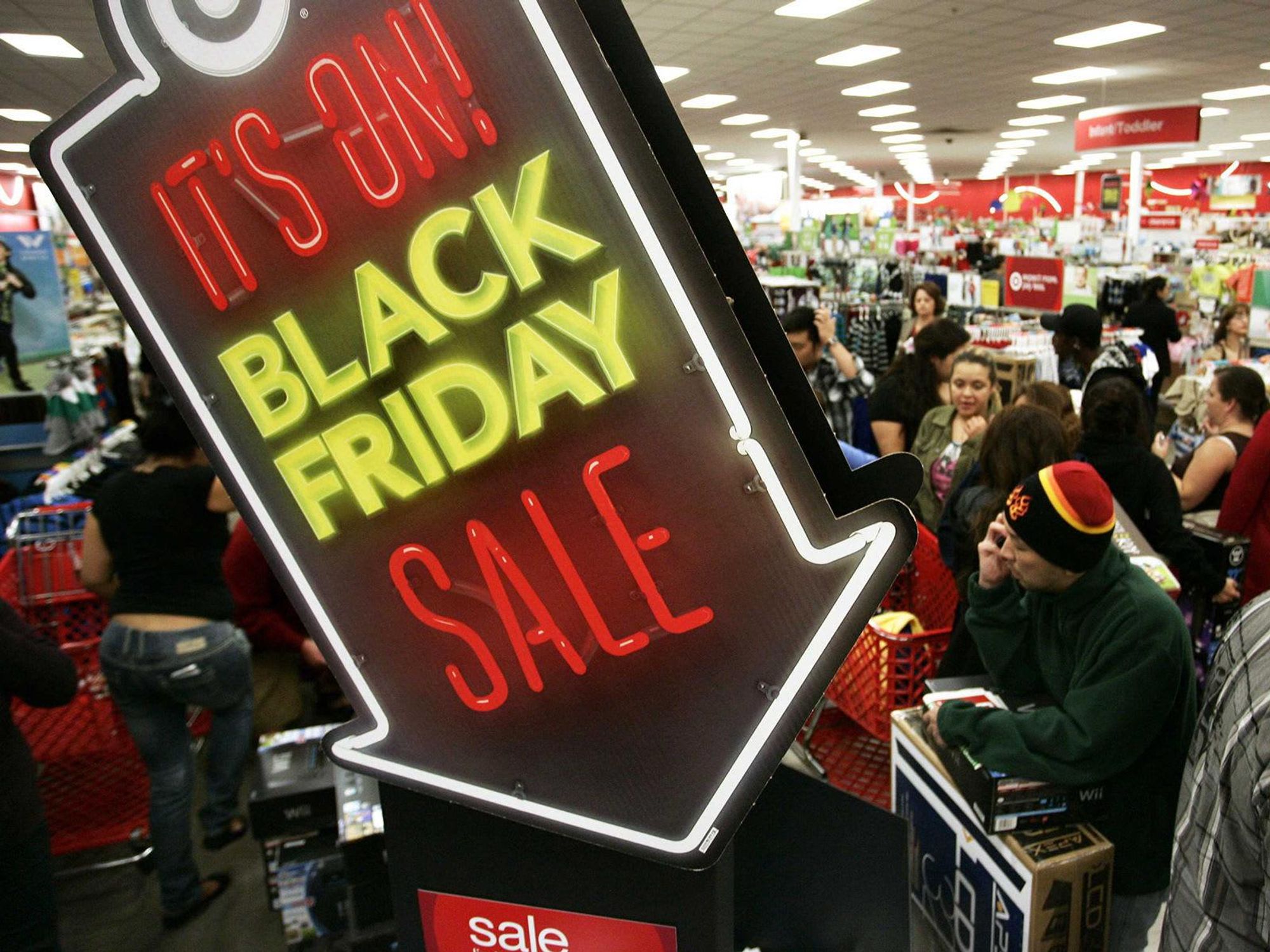 Black Friday neon sign and shoppers