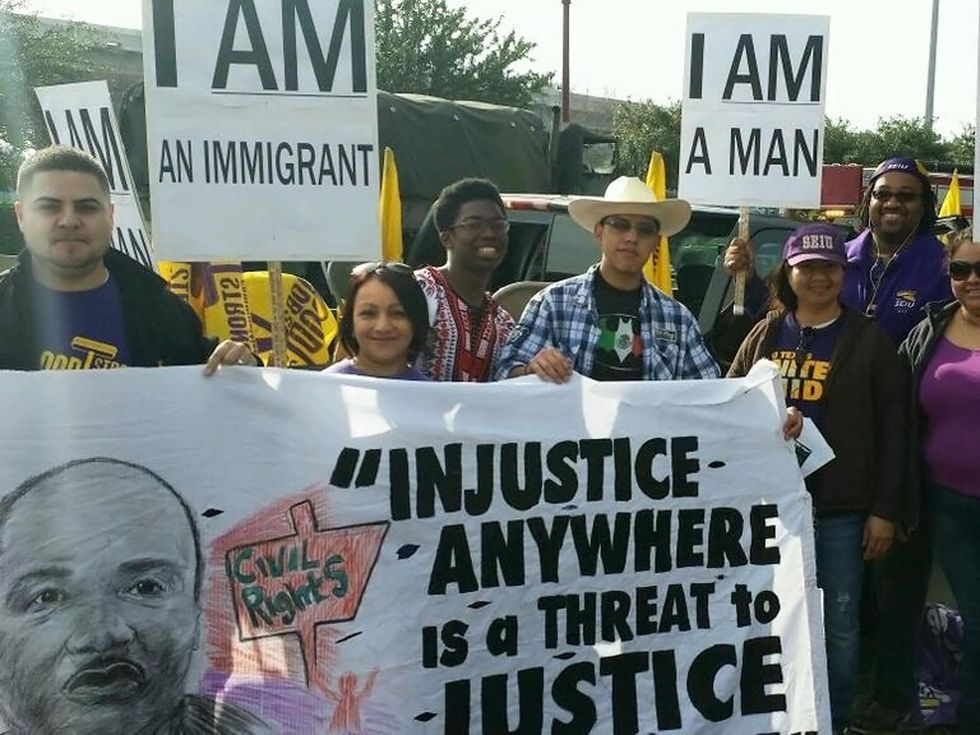 Black Heritage Society of Houston Original MLK Parade members of crowd holding signs January 2014
