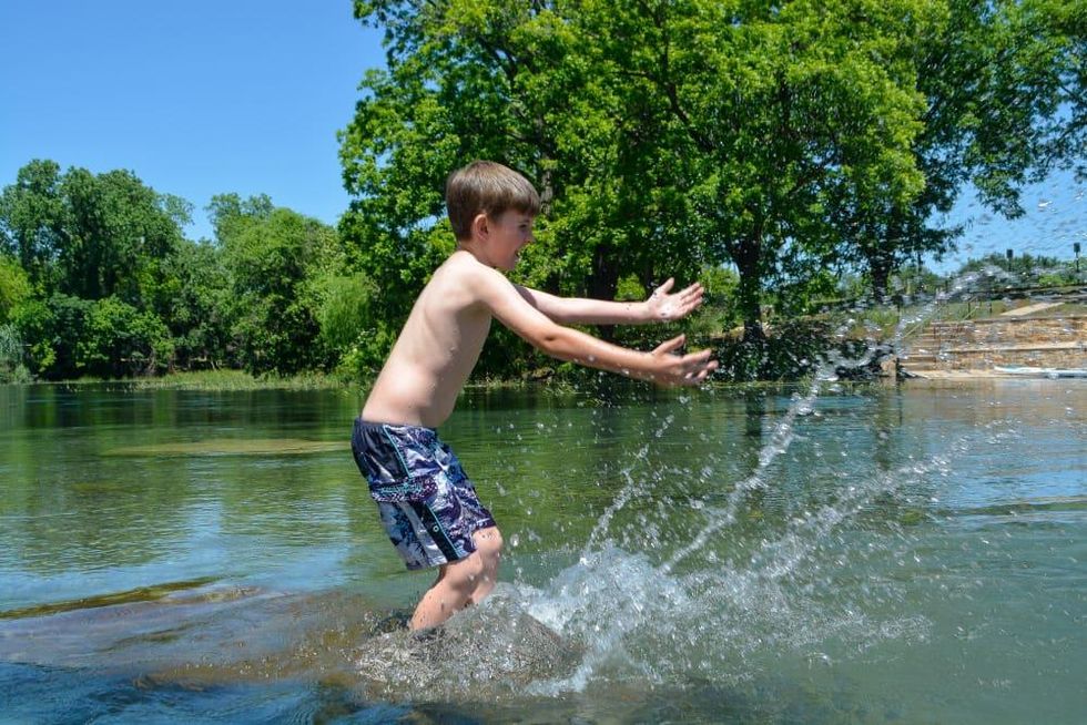 Boy splashing in the San Marcos River