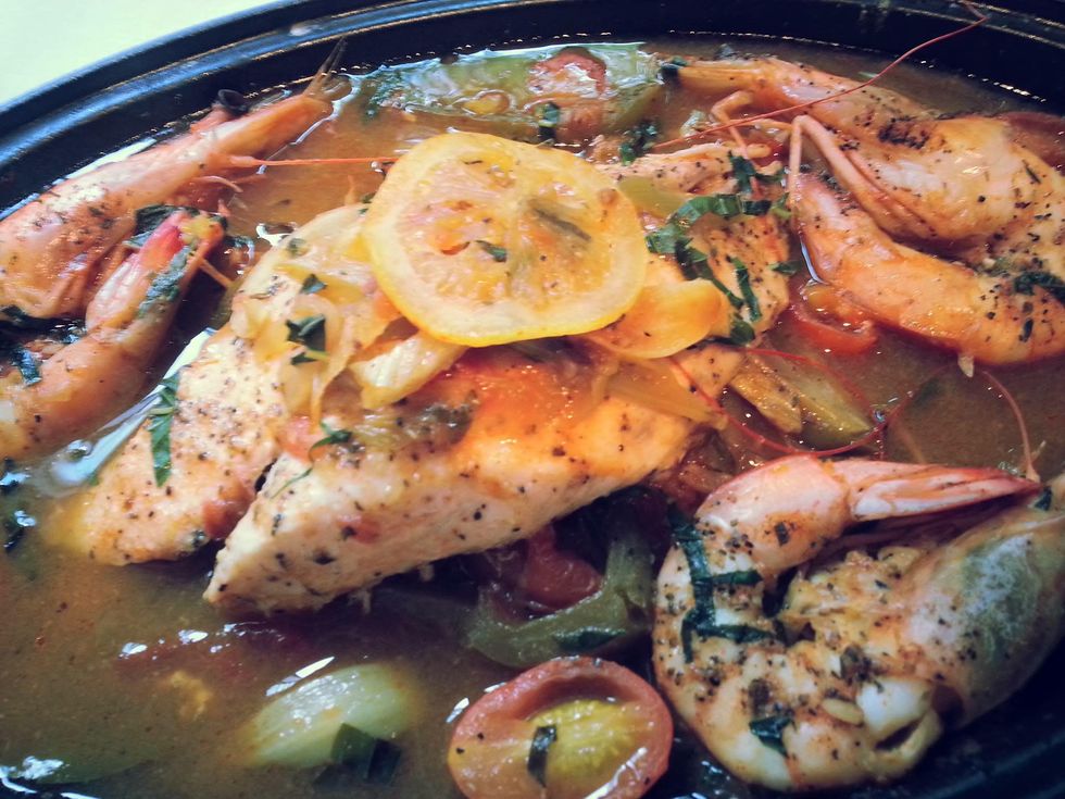 Brennan's of Houston redfish Haute Creole with wild Texas shrimp in Acadian style courbouillon sauce over toasted garlic Jazzmen Rice