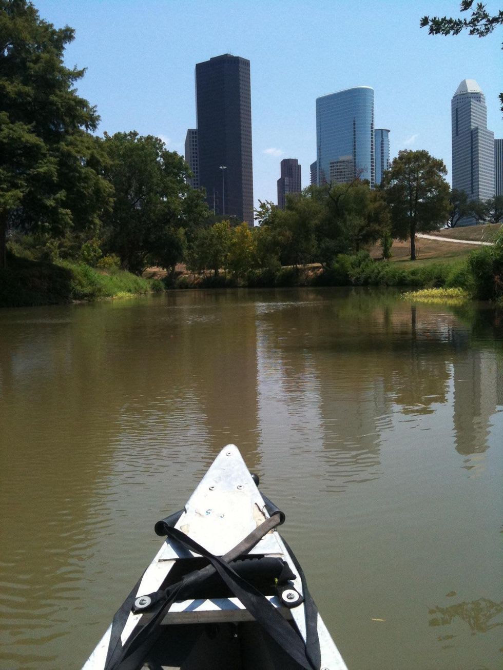 Buffalo Bayou with canoe in foreground and skyline in background