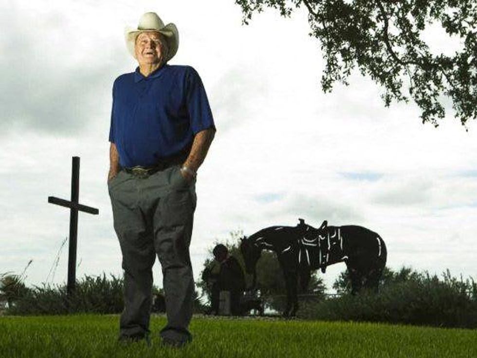 Bum Phillips with cross behind him