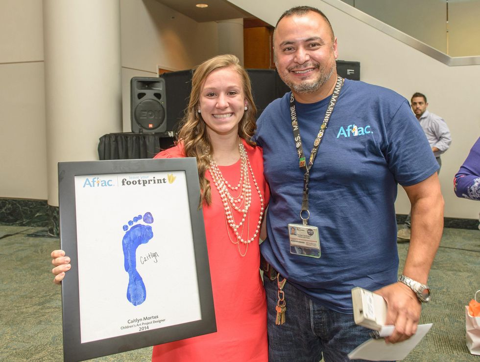Caitlyn Mortus a patient designer posed with Leon Childrens Arts project coordinator%2C was honored at Aflac Duckprints Award at MD Anderson
