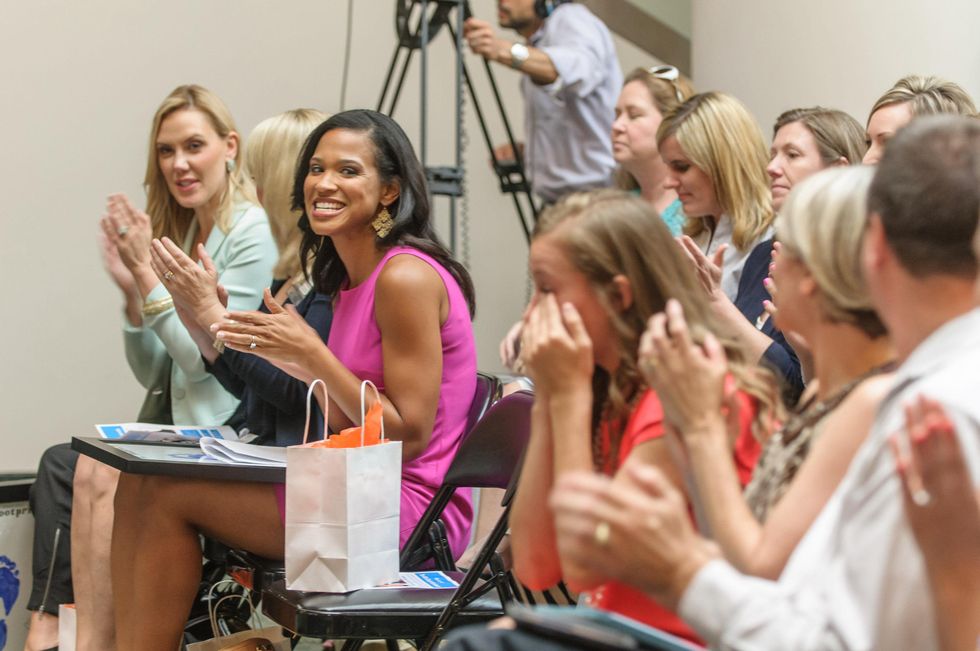 Caitlyn Mortus wipes her tears after her speech at Aflac Duckprints Award at MD Anderson