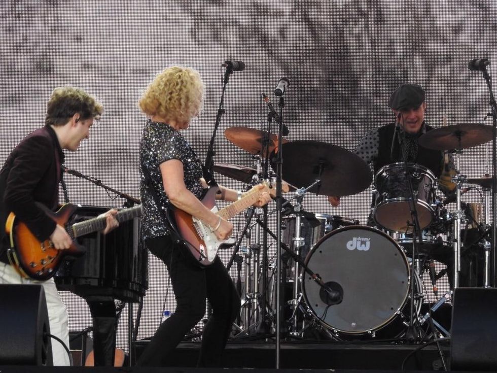 Carole King at London concert playing guitar