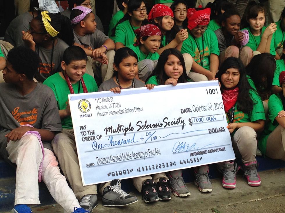 Chalk the Walk for MS sidewalk chalk art contest October 2013 check held by students