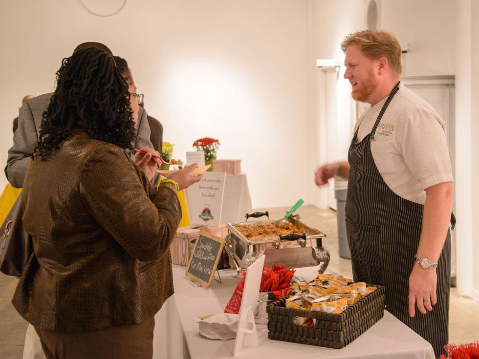 Chef Randy Evans of Haven serving mac n' cheese frito pie at the Camp for All Culinary Challenge November 2013