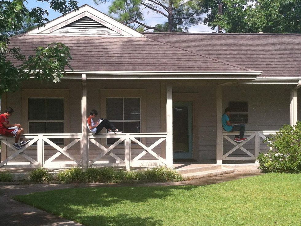 Chinquapin Preparatory School student studying on house porch