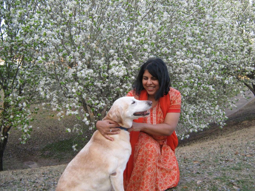 Chitra Divakaruni with dog and flowers
