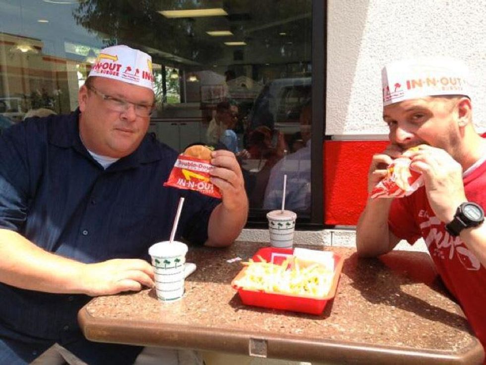 Chris Shepherd eating an In-N-Out Double Double burger with Underbelly sous chef Ryan Lachaine June 2013