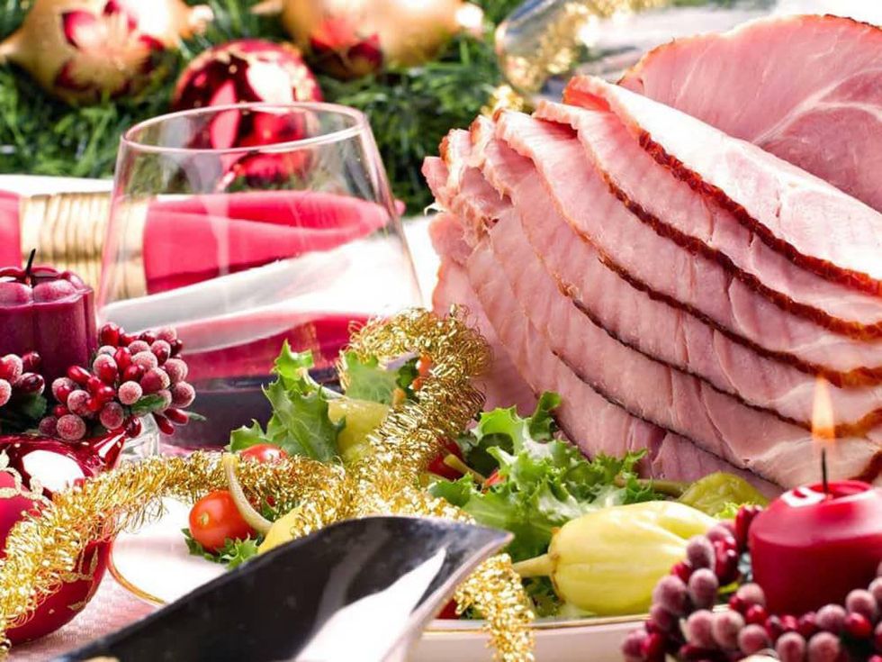 Christmas dinner with ham and red wine and candles