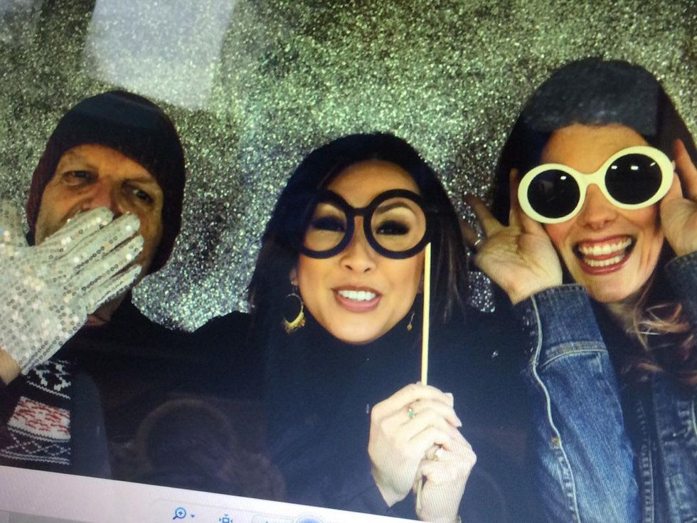 Clifford Pugh, Lily Jang and Brittany Havican take photo in PhotoMoto booth