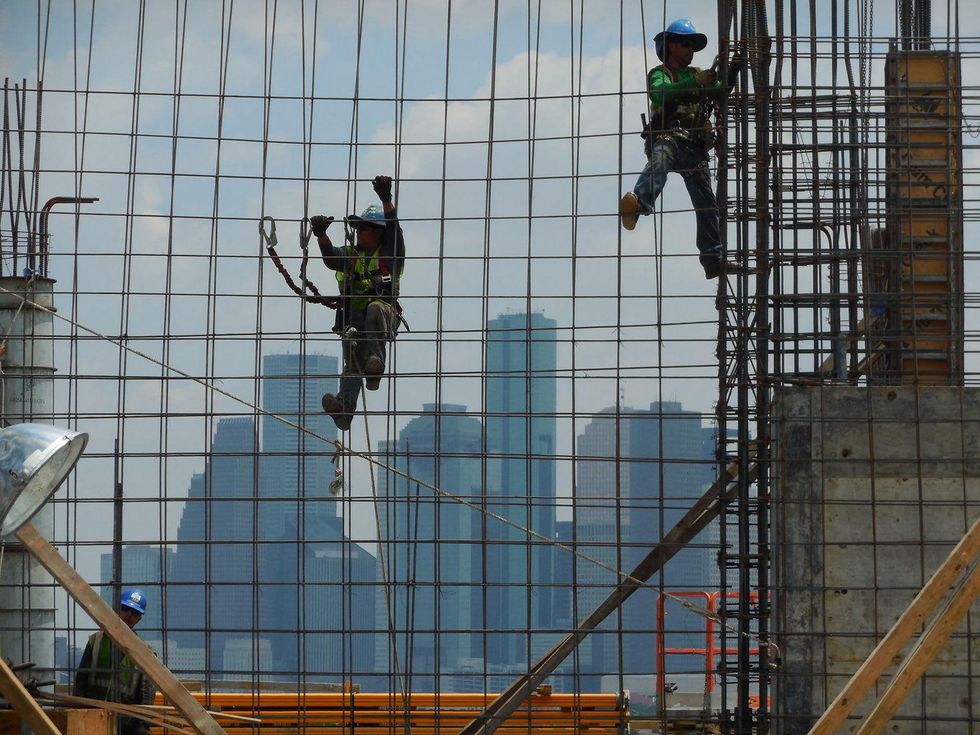 construction workers with Houston skyline in background
