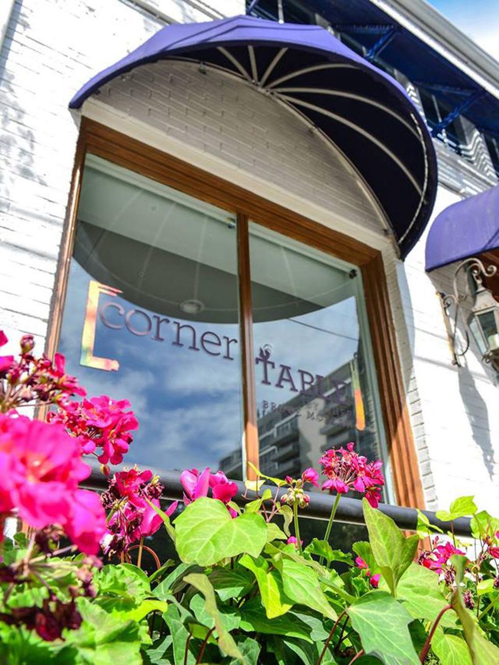 Corner Table exterior with sign and flowers