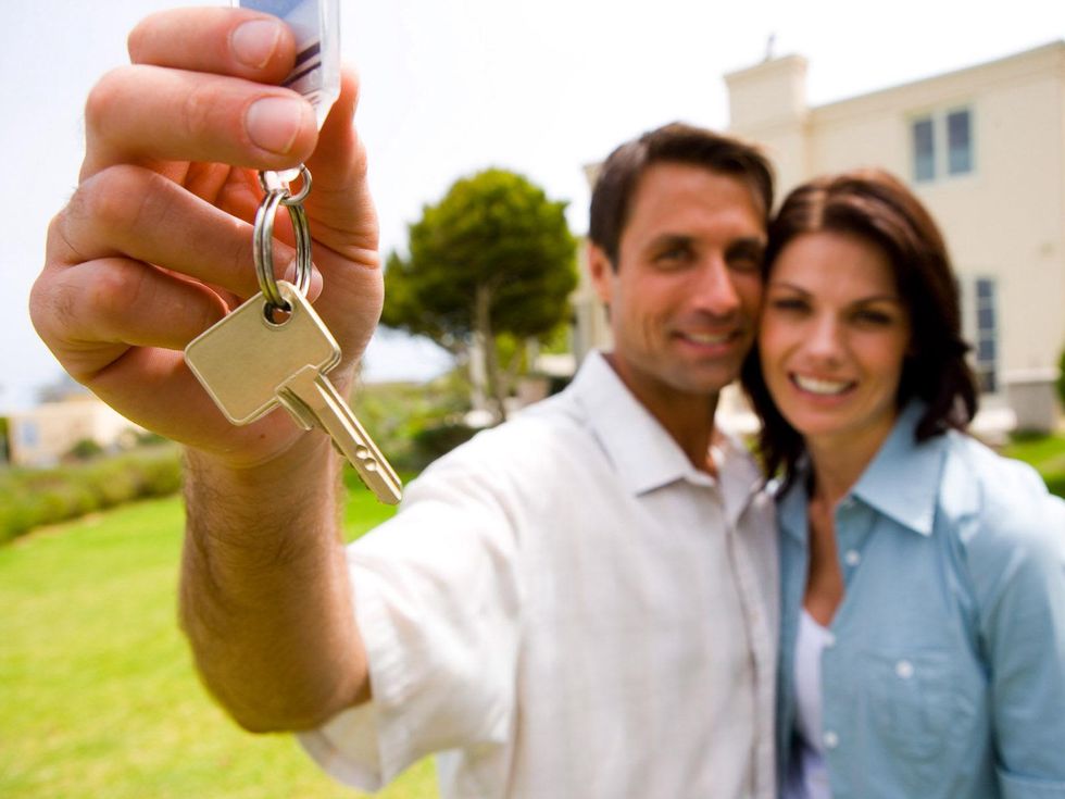 couple holding keys to new house