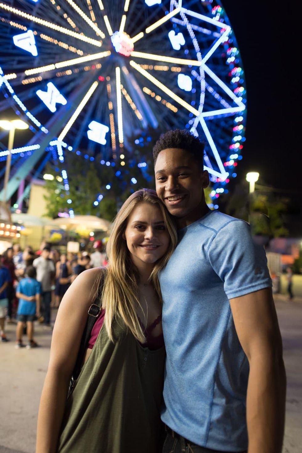 Couple posing in front of the Texas Star Ferris wheel
