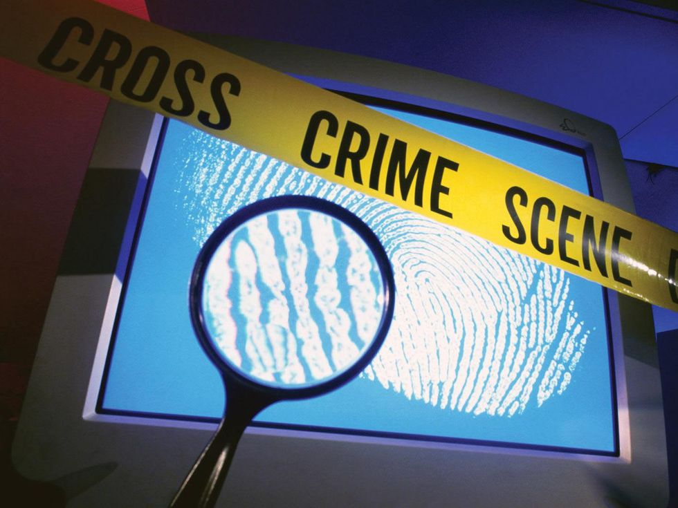 crime scene tape magnifying glass computer screen cybercrime