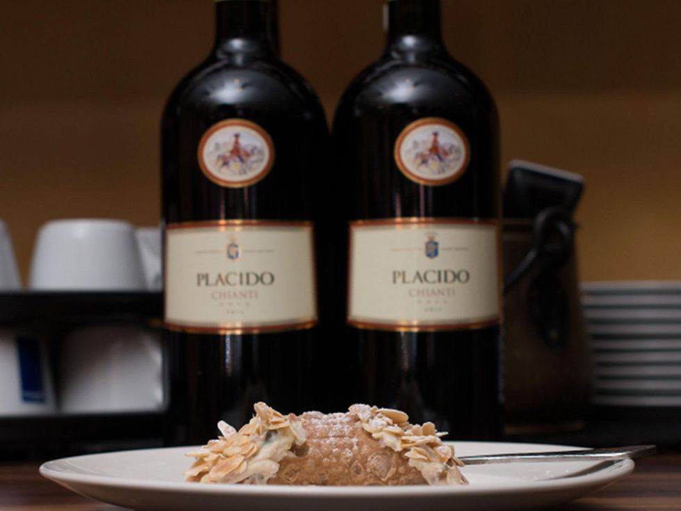 D'Amicos in Katy October 2013 cannoli with wine bottles in the background