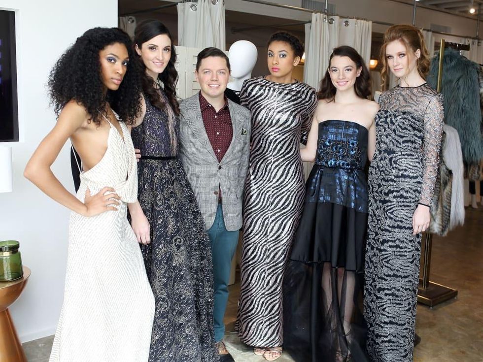 David Peck with models at Miles David fashion show