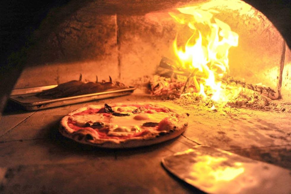 Debora Smail Da Marco Cucina E Vino pizza in pizza oven with fire