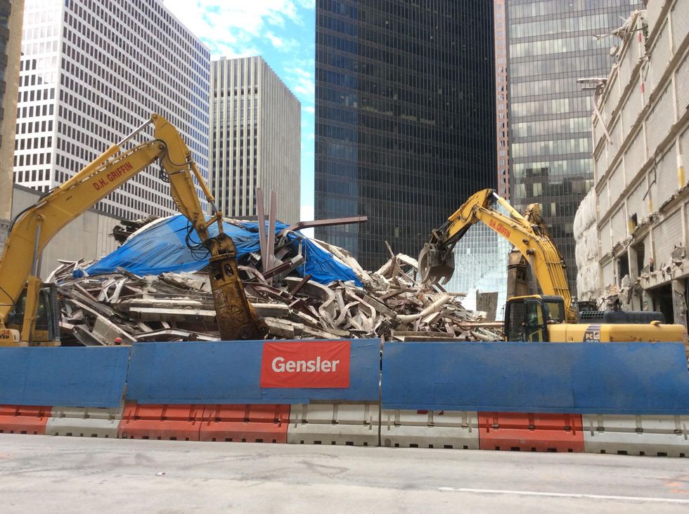 Debris is cleared from Houston Club implosion site. A 35-story office tower will be built there by Skanska October 2014