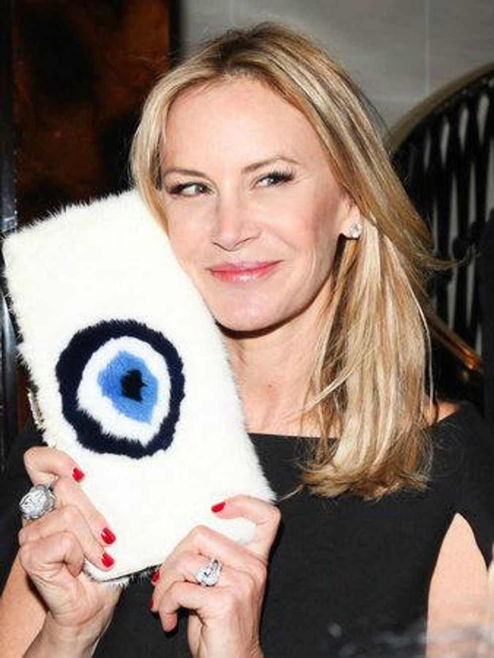 Dee Ocleppo with mink evil eye clutch at Plaza apartment