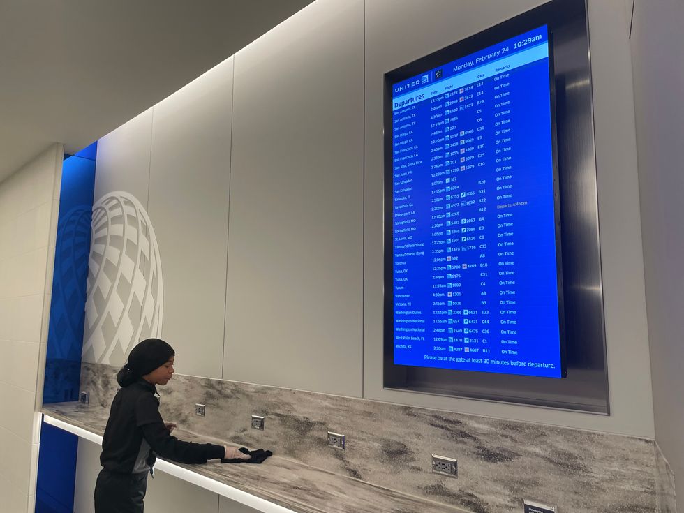 Departure board at United Club Fly