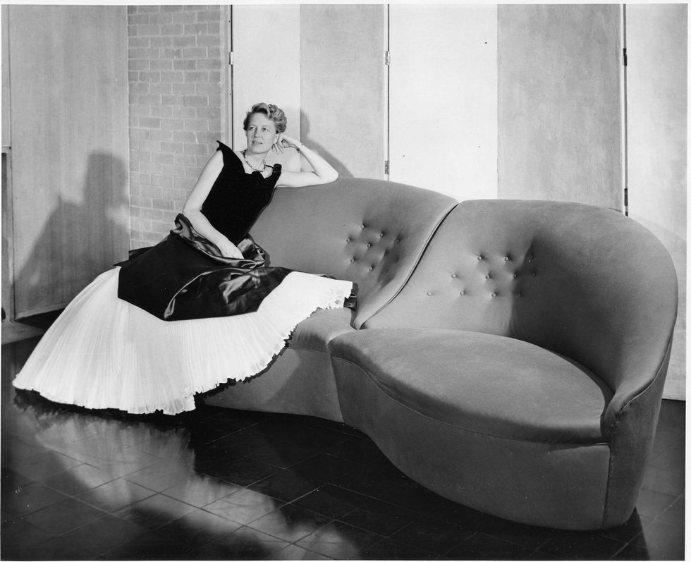 Dominique de Menil in Charles James gown on Lips sofa