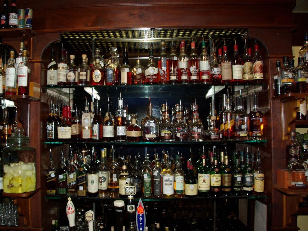Downing Street Pub & Cigar Bar bar with wall of whiskey
