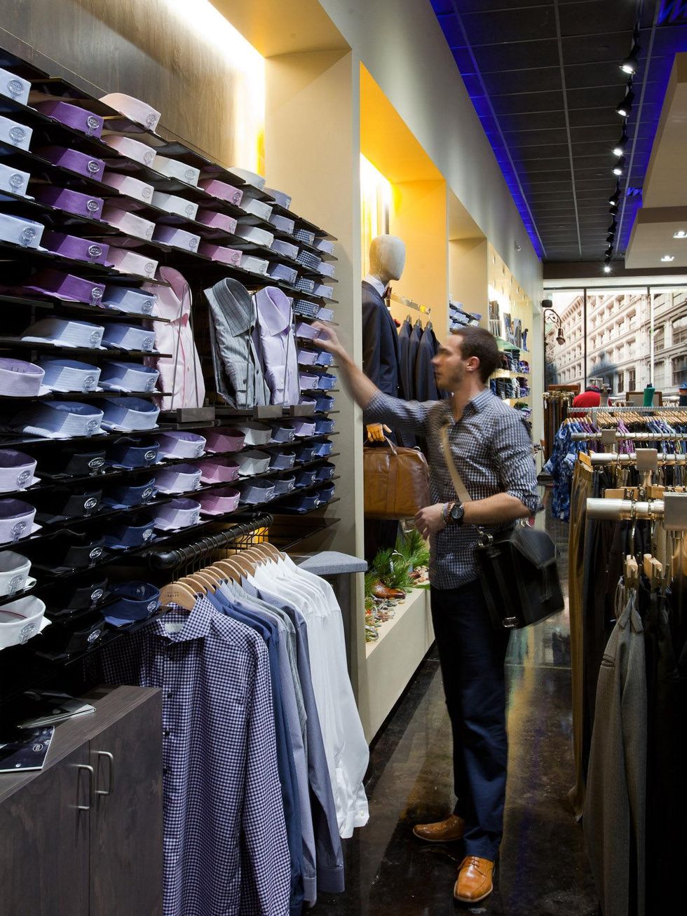 Dryden Kreps men's clothing store with shirts and a male shopper