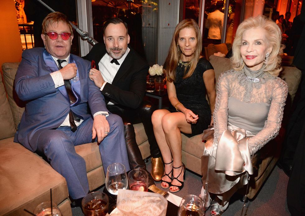Elton John, David Furnish, unidentified woman and Lynn Wyatt attend the 2015 Vanity Fair Oscar Party