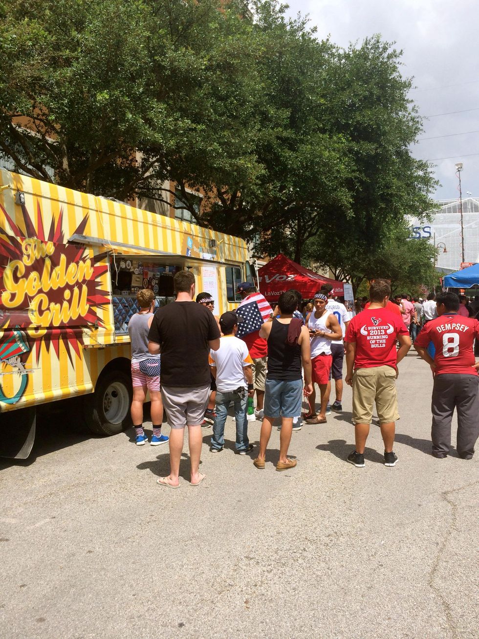 Fans at food truck at Lucky's Pub for USA vs. Belgium soccer game.