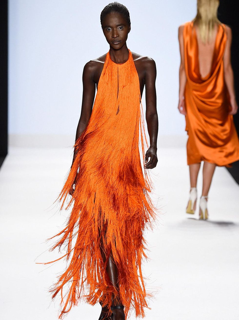 Fashion Week spring 2015 Project Runway model in orange fringe dress