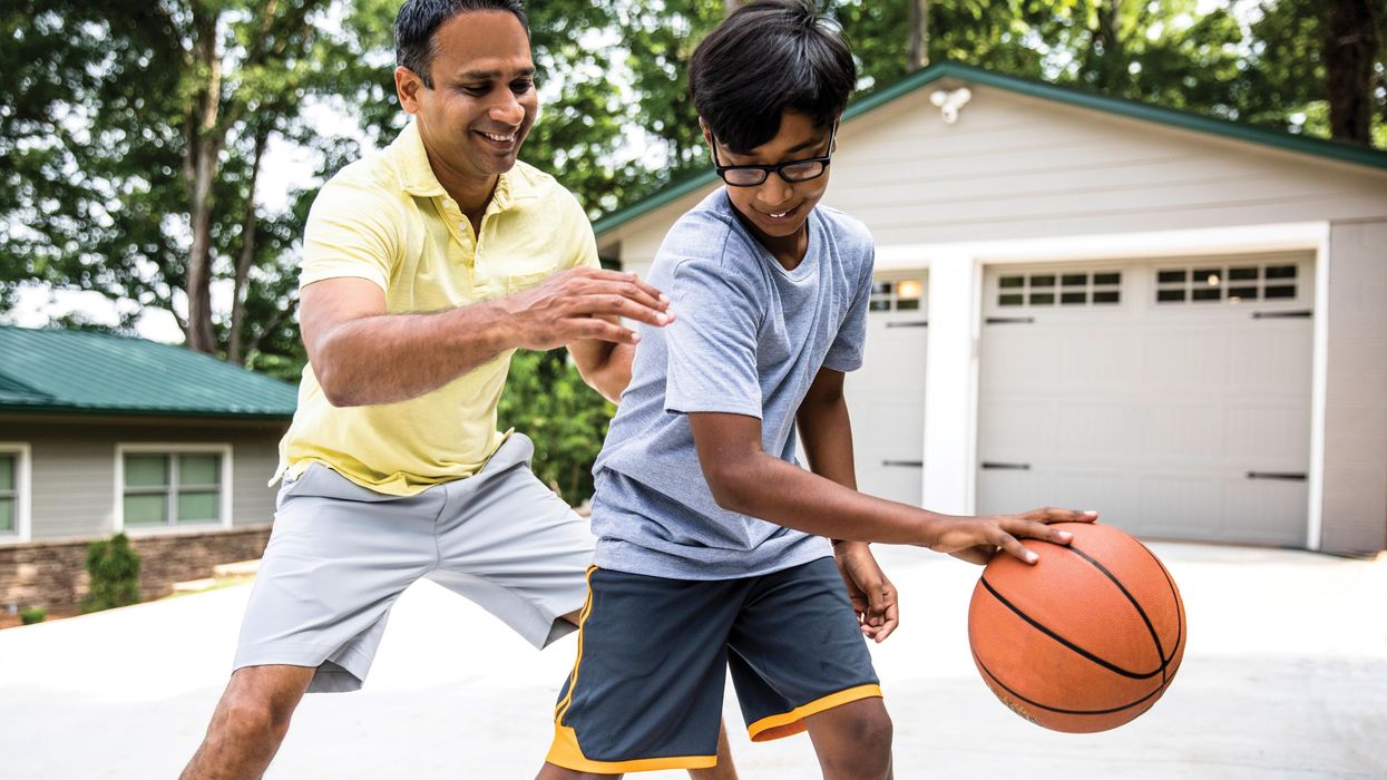Father and son playing basketball