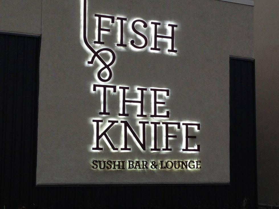 Fish & The Knife Sushi Bar & Lounge sign at night