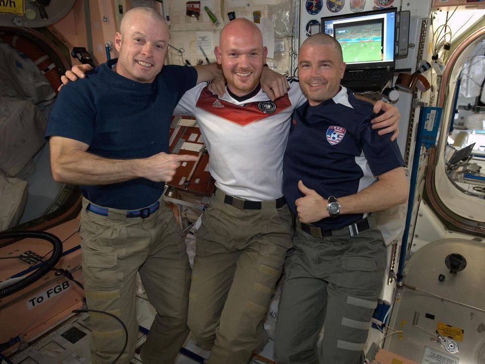 Flight Engineer Alexander Gerst poses with Commander Steve Swanson (left) and Flight Engineer Reid Wiseman dawning freshly shaved heads