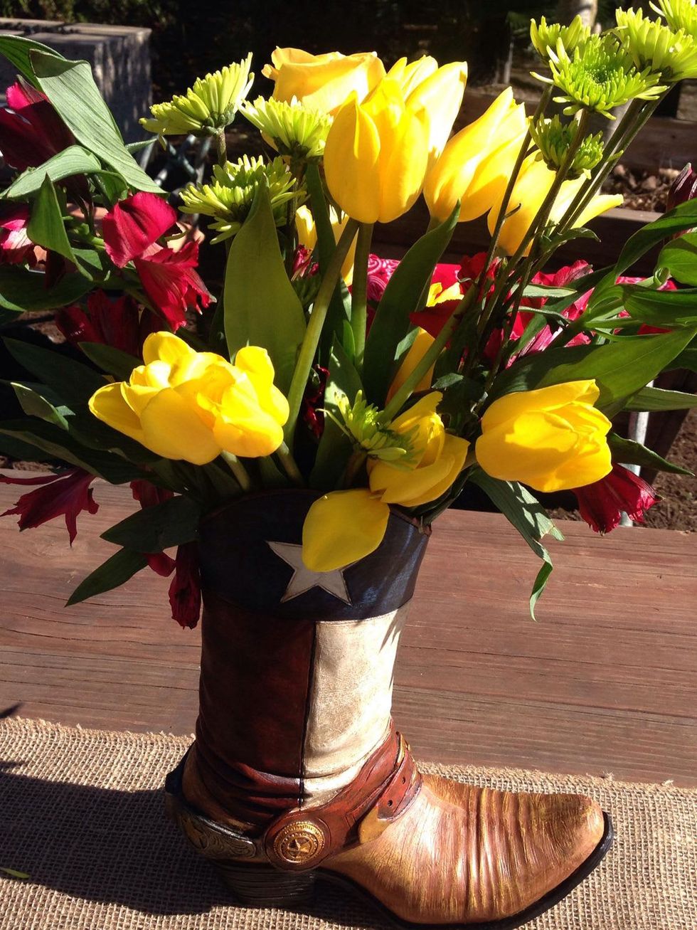 Flower arrangement in cowboy boot at Casey Curry baby shower January 2014