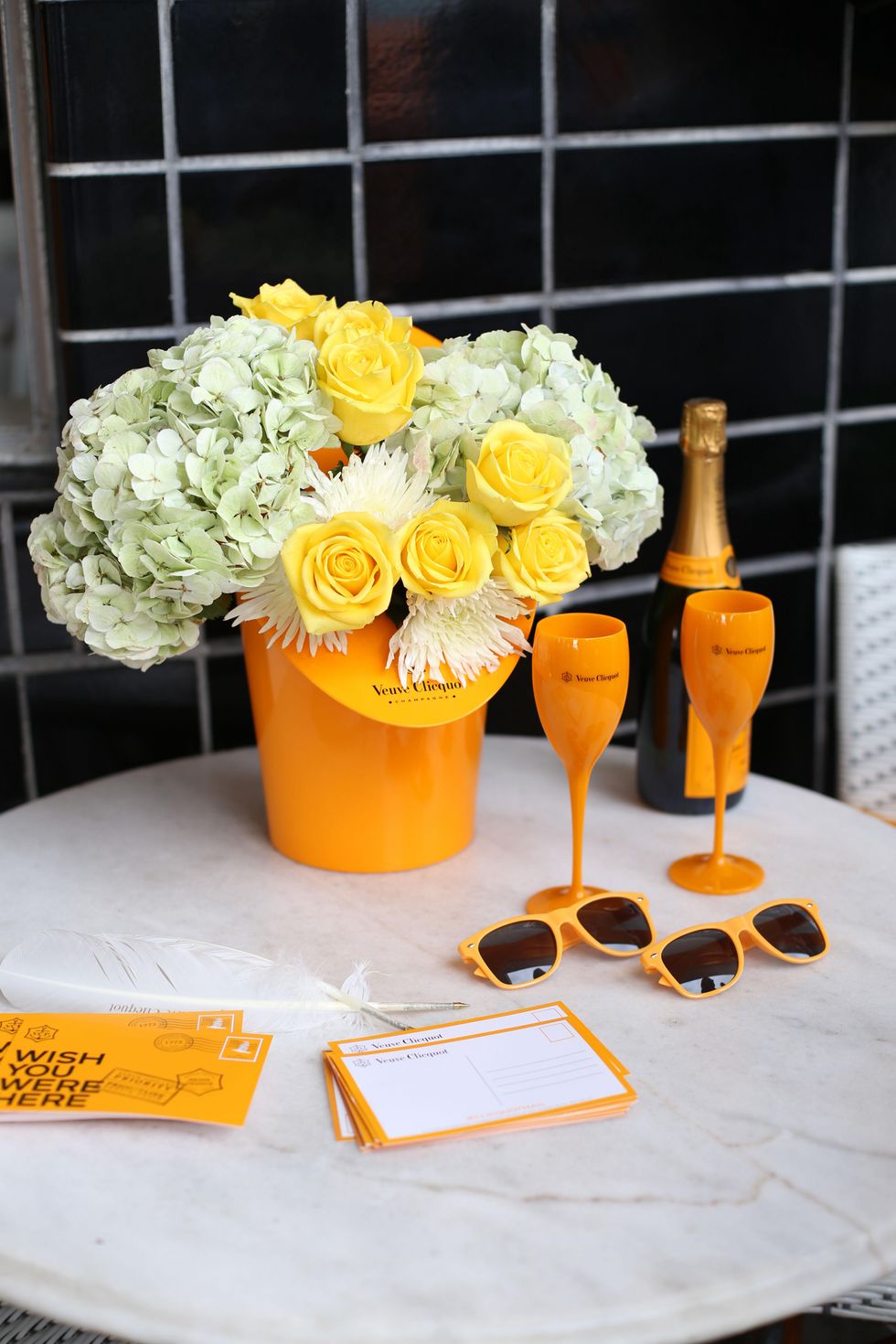 Flower arrangement with note cards and sunglasses at Veuve Clicquot at Brasserie 19