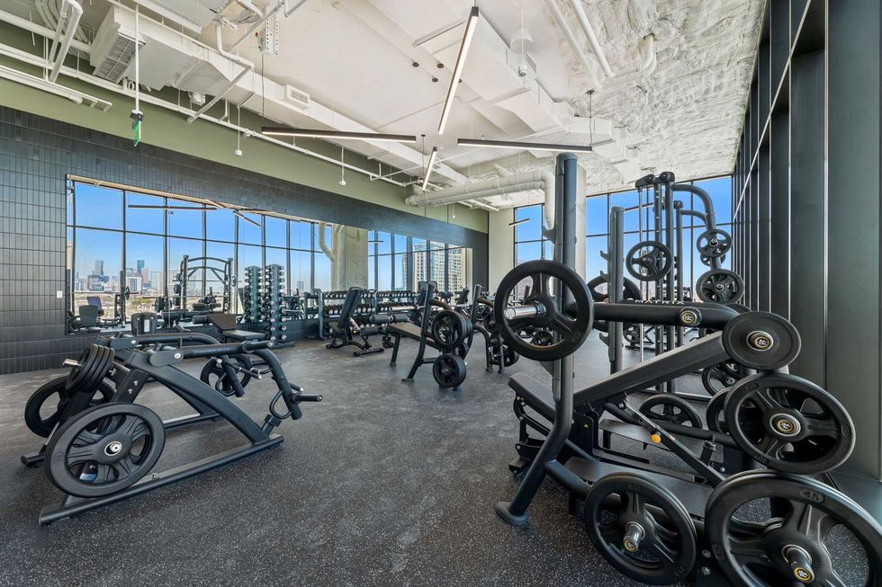 Forme apartment building gym interior with weights and panoramic views