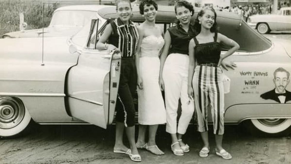 'Four young women standing beside a convertible automobile, ca. 1958' from \u201cThe Negro Motorist Green Book.\u201d
