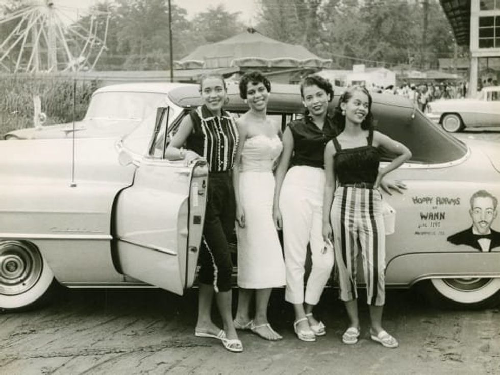 'Four young women standing beside a convertible automobile, ca. 1958' from \u201cThe Negro Motorist Green Book.\u201d