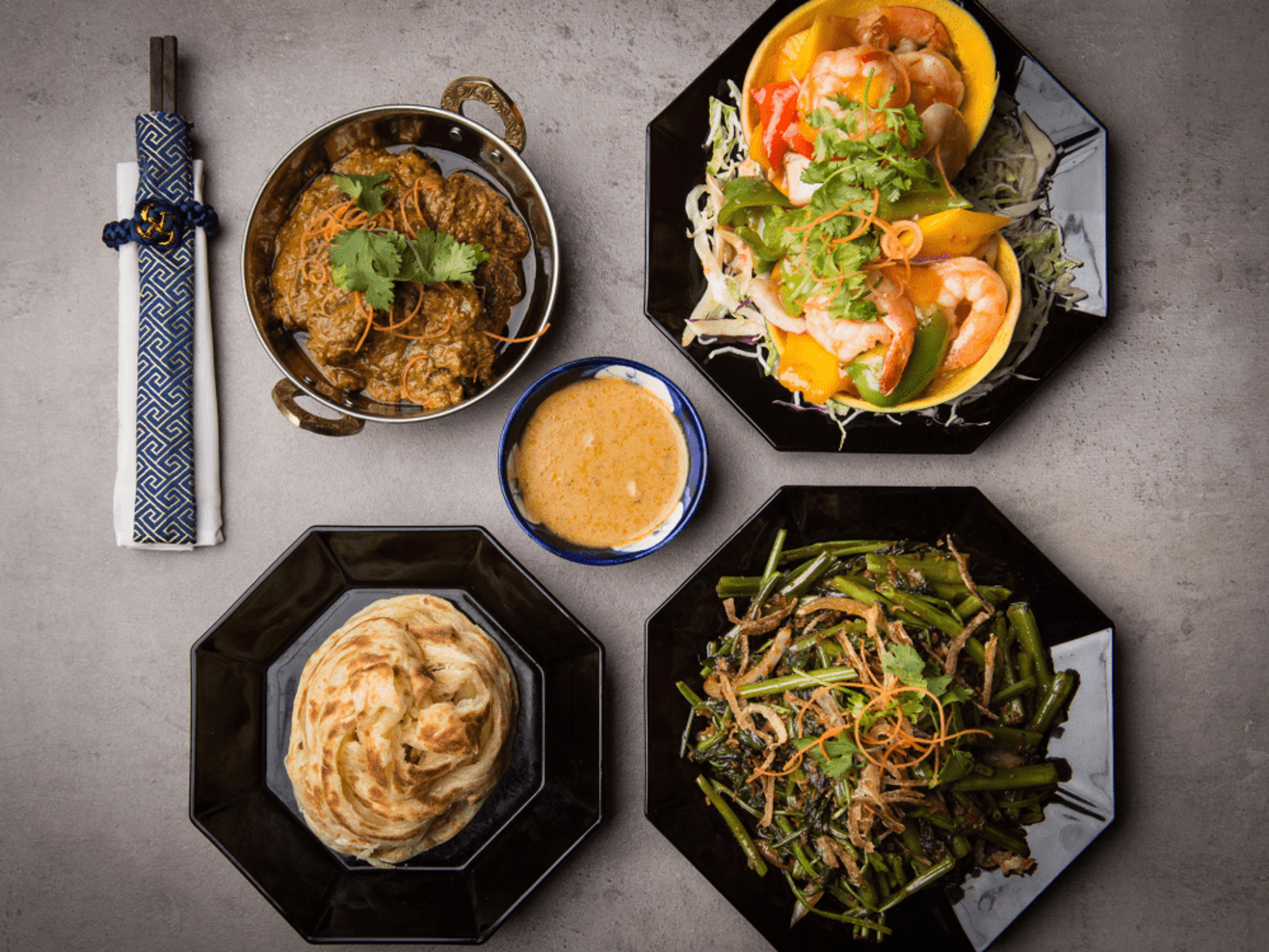 From top right: Beef rendang, mango prawn, Kang Kung, and roti.