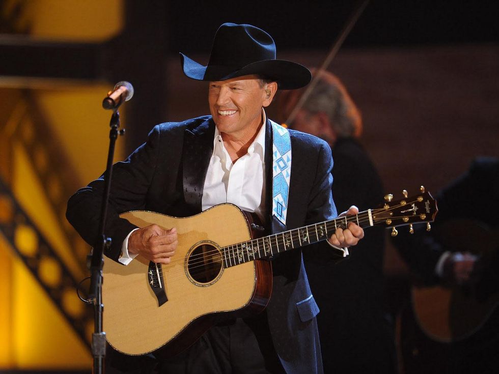 George Strait, with guitar, smiling