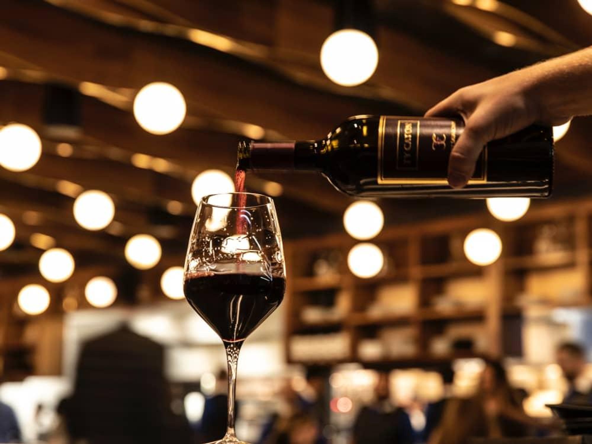 Georgia James wine pouring