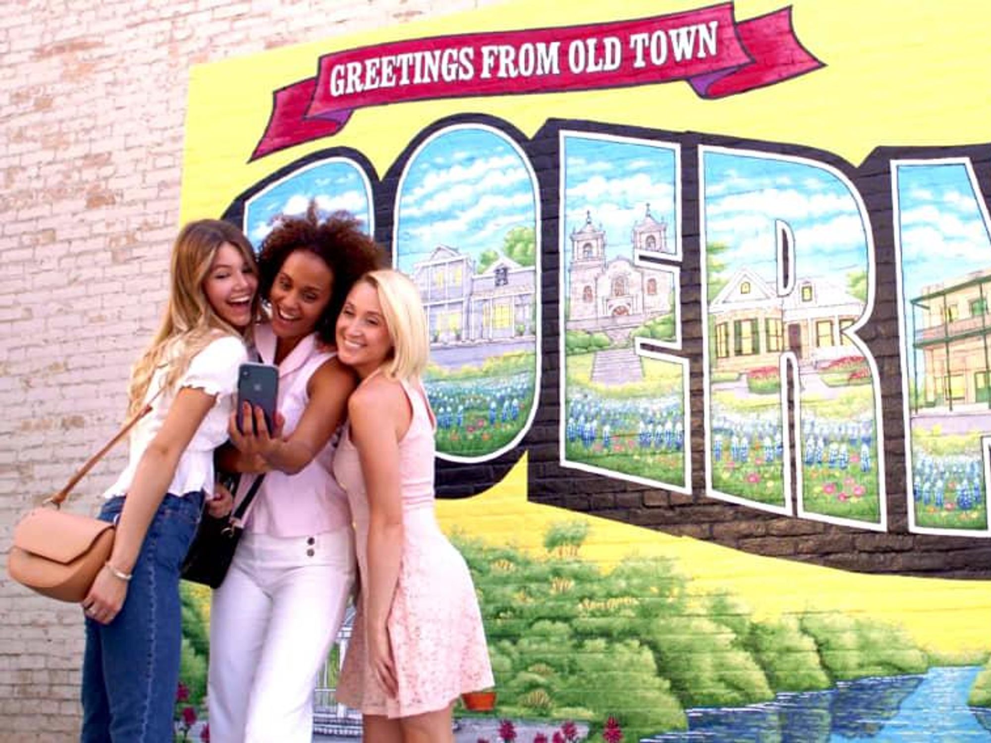 girls in front of boerne mural