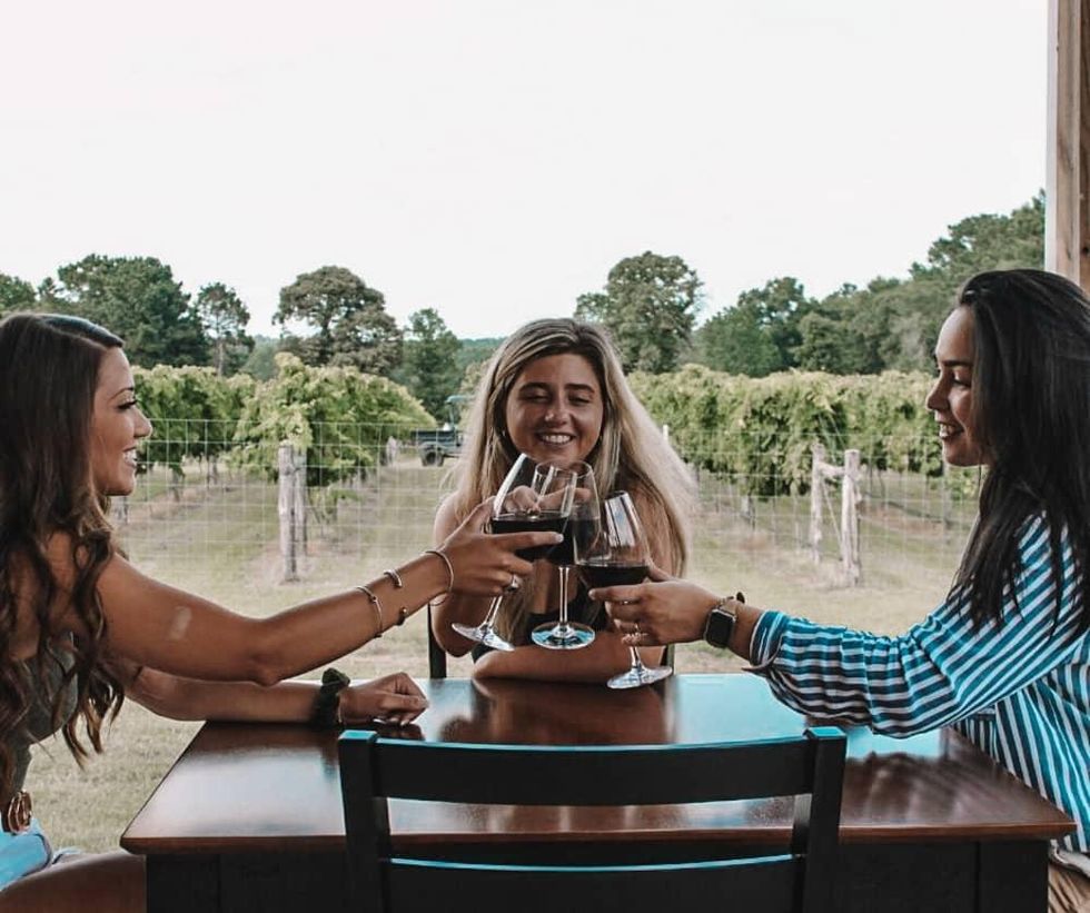 girls tasting wine on sam houston wine trail