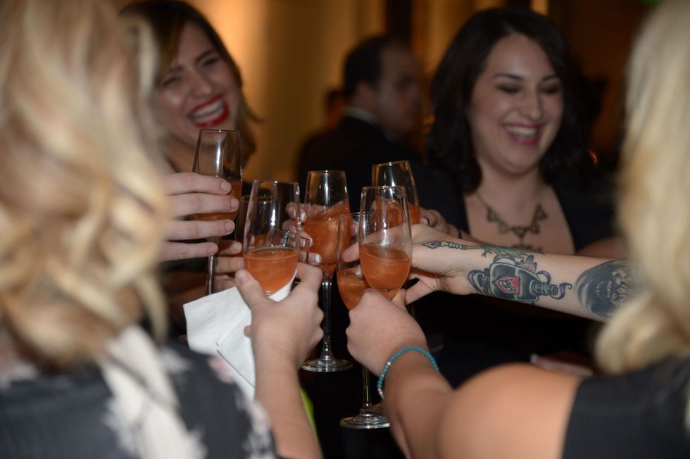 girls toasting at the David Peck runway show September 2014